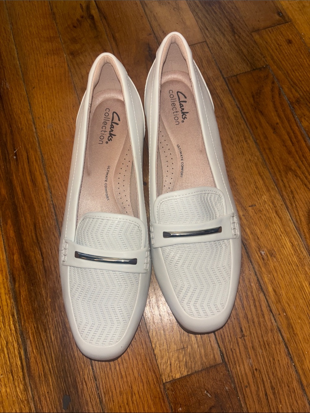 Clarks Women's Cream Slip-On Loafers with Silver Accent